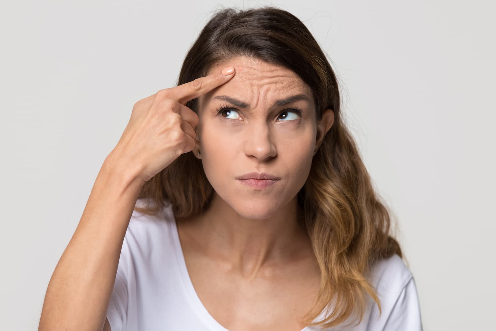 young woman touch forehead worried about skin wrinkle